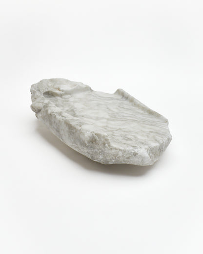 Angled view: gray-green alabaster tray with gray streaks, beige flecks, smooth and raw edges.