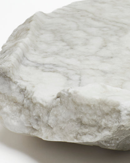 Close-up: light gray-green alabaster tray with gray streaks.