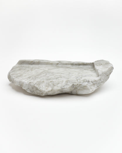 Side view: gray-green alabaster tray with gray streaks, beige flecks, smooth and raw edges.