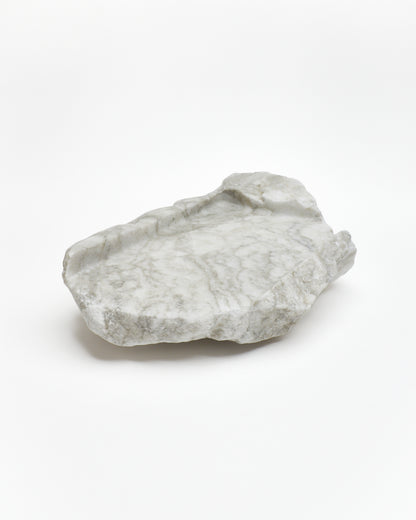 Angled view: gray-green alabaster tray with gray streaks, beige flecks, smooth and raw edges.