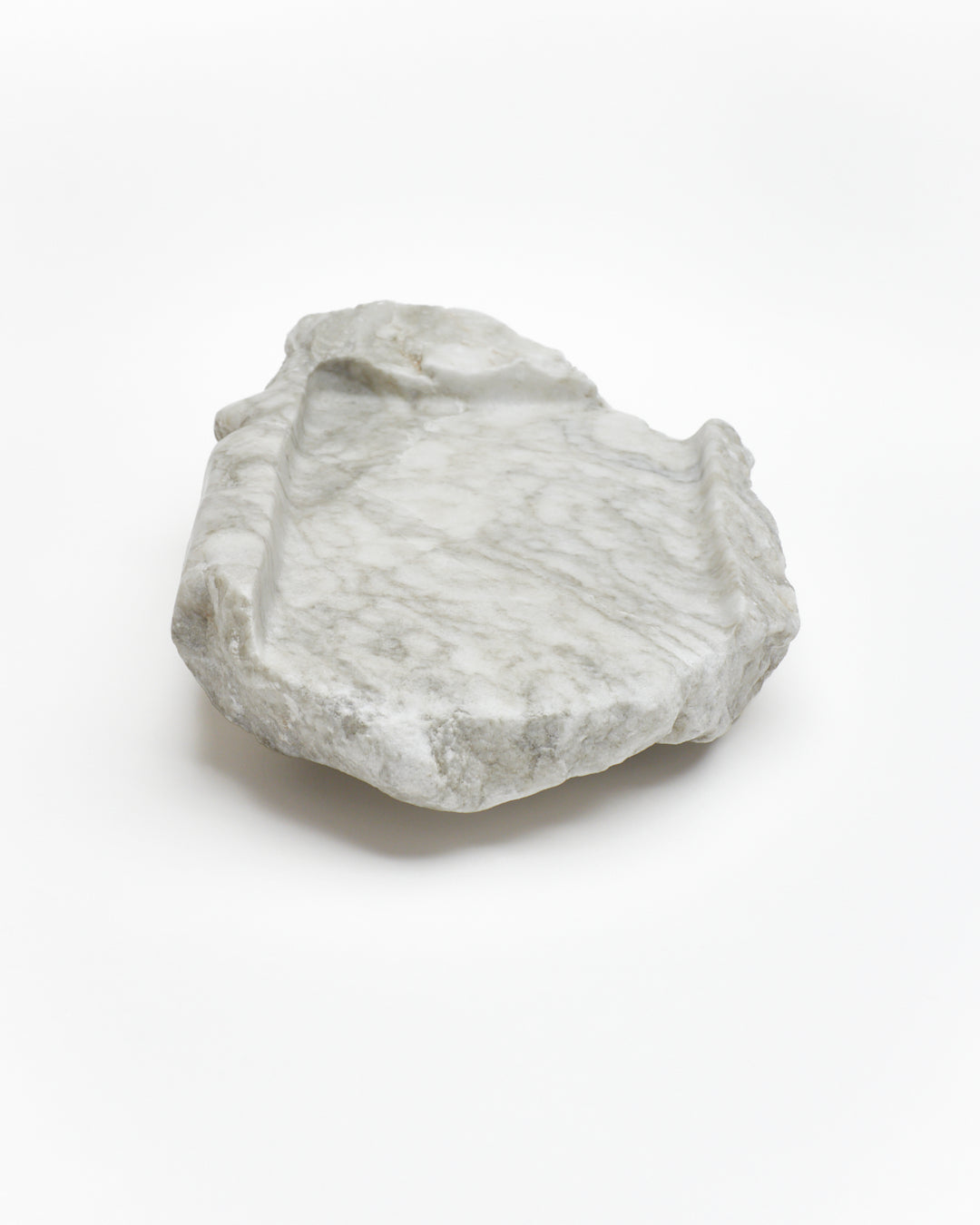 Front view: gray-green alabaster tray with gray streaks, beige flecks, smooth and raw edges.