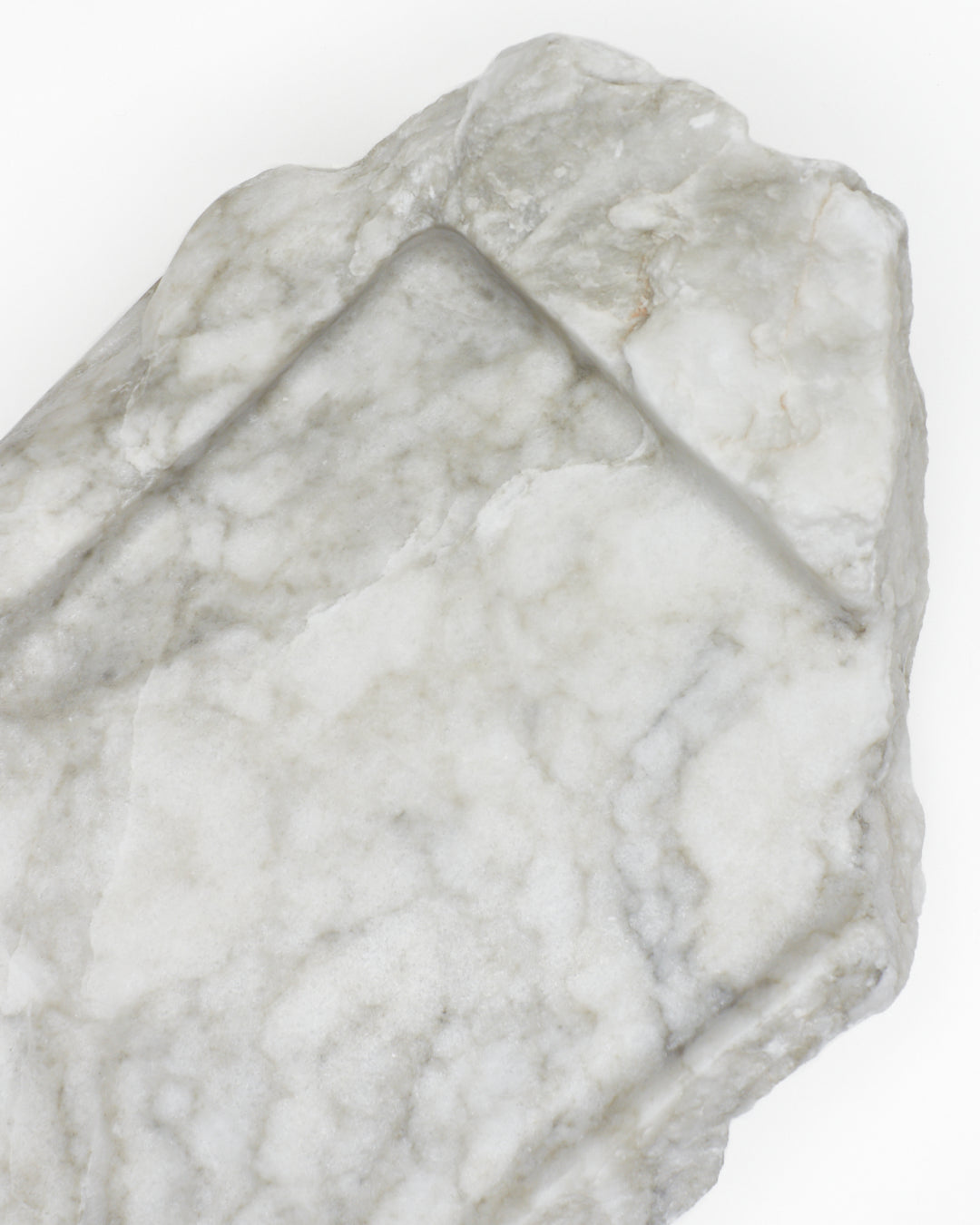 Top-down close-up: light gray-green alabaster tray, gray streaks, light veining, beige flecks.