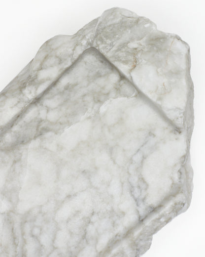 Top-down close-up: light gray-green alabaster tray, gray streaks, light veining, beige flecks.