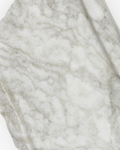 Top-down close-up: light gray-green alabaster surface, gray streaks, and light veining.