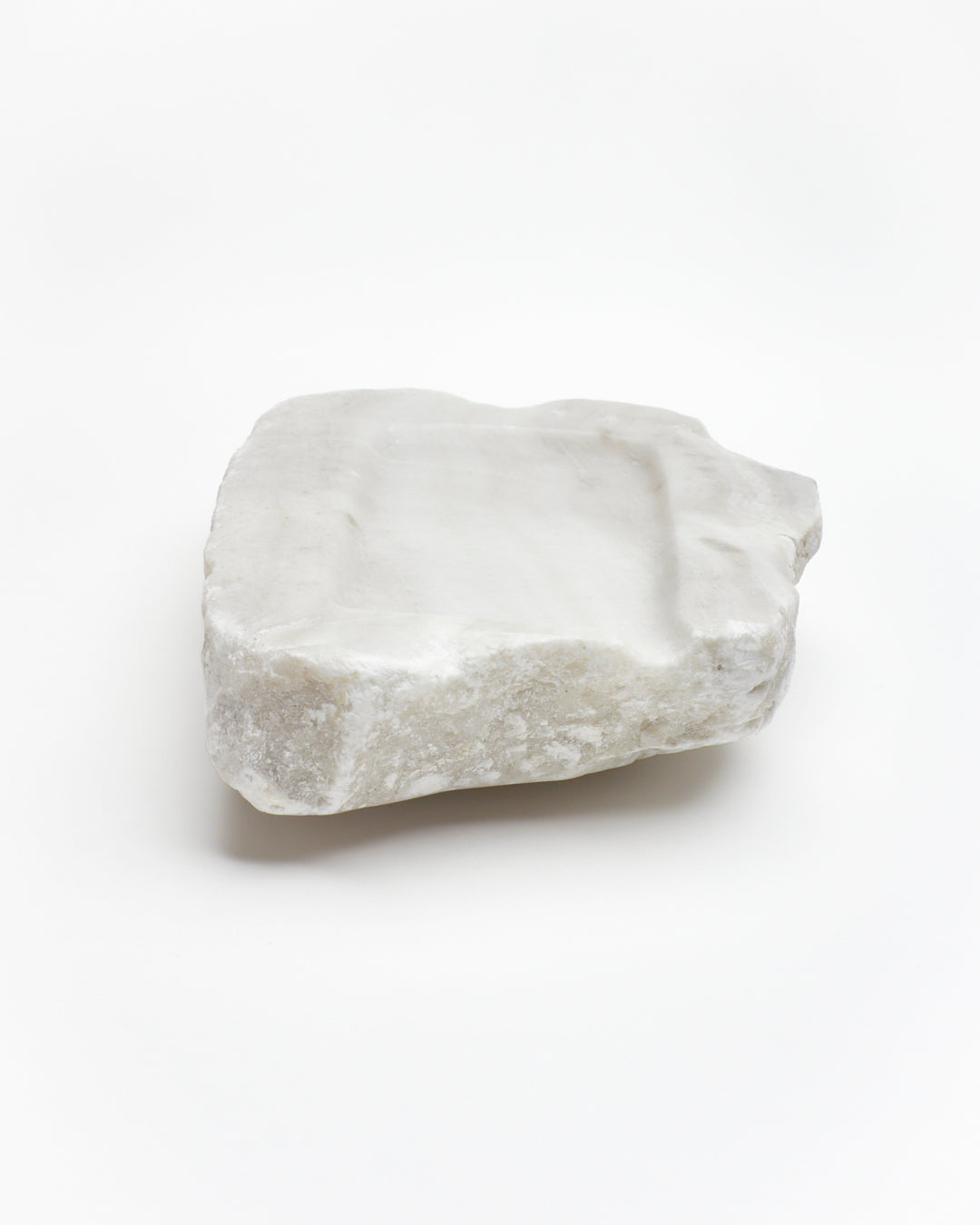 Front view: organic-rectangle off-white alabaster tray with raw edges and subtle marks.