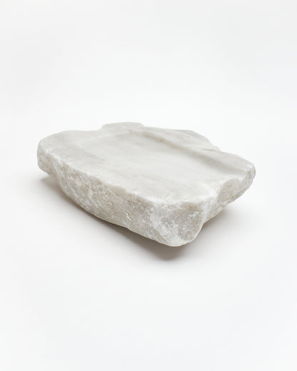 Angled view: organic-rectangle off-white alabaster tray with raw edges and subtle marks.