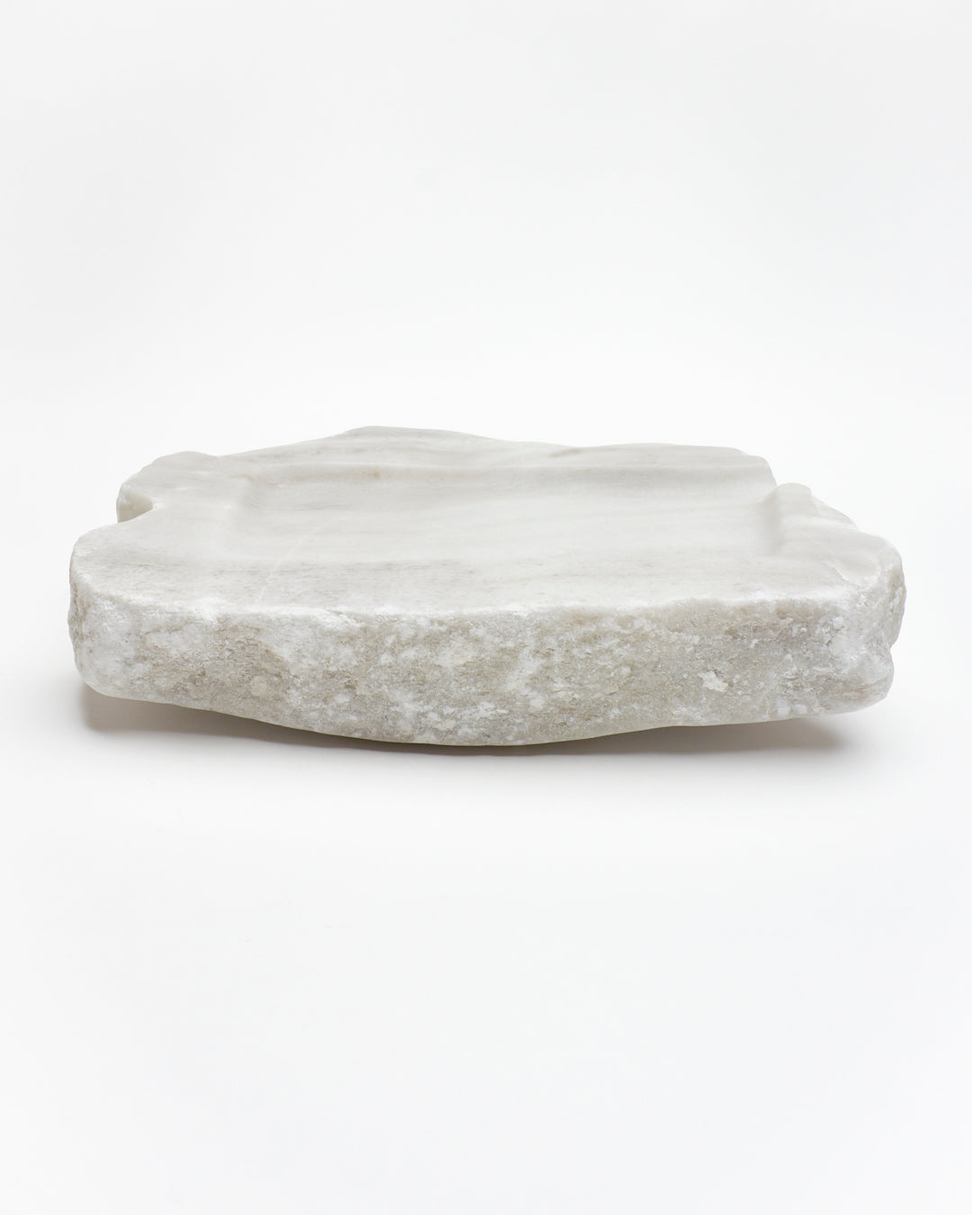 Side view: organic-rectangle off-white alabaster sculpture with raw edges, subtle marks, and flecks.