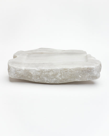 Side view: organic-rectangle off-white alabaster sculpture with raw edges, subtle marks, and flecks.
