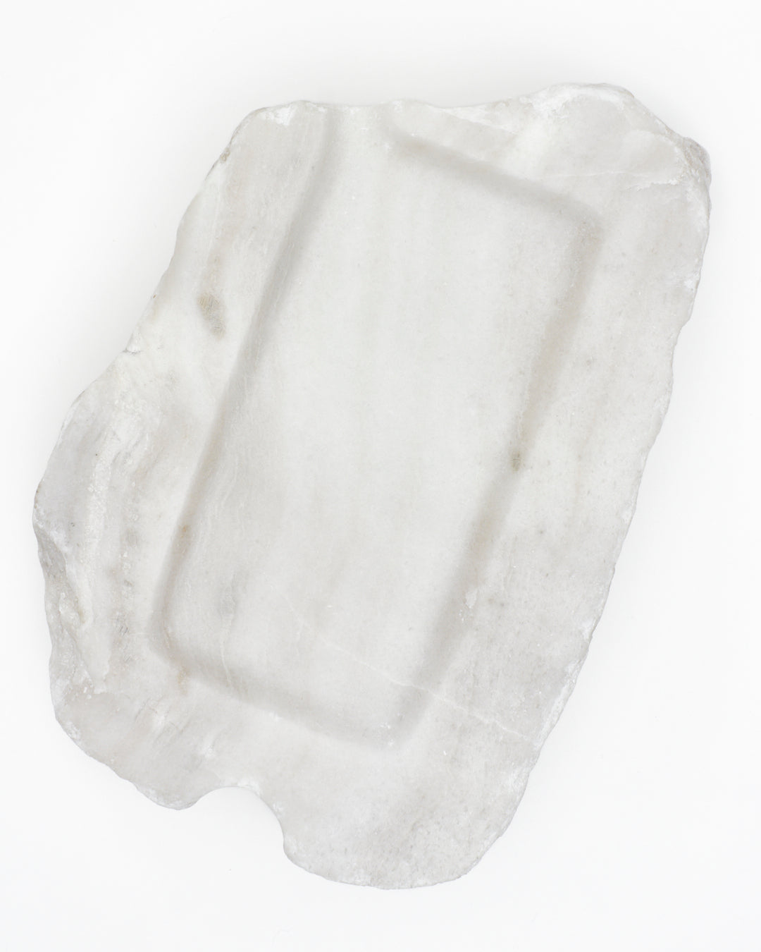 Top-down: organic-rectangle off-white alabaster tray, subtle marks, semicircle cutout.