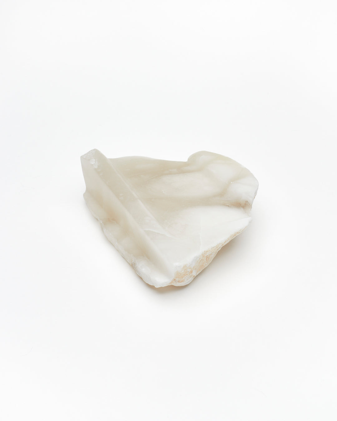 Angled back view: white translucent alabaster tray with brown flecks, raw and smooth edges.