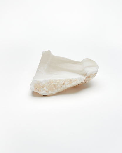 Back view: white translucent alabaster tray with brown flecks, and raw edges.