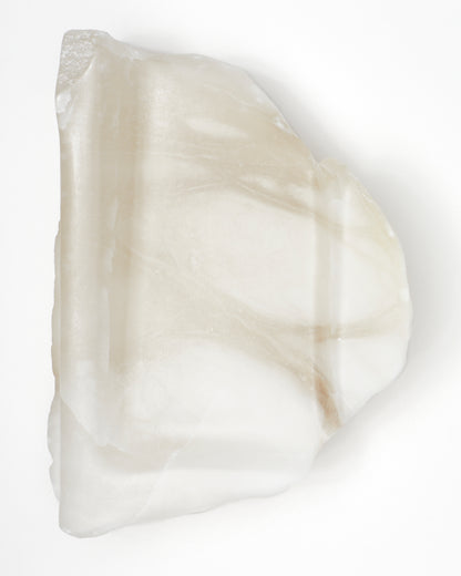 Top-down view: organically shaped, white translucent alabaster tray with a smooth surface.