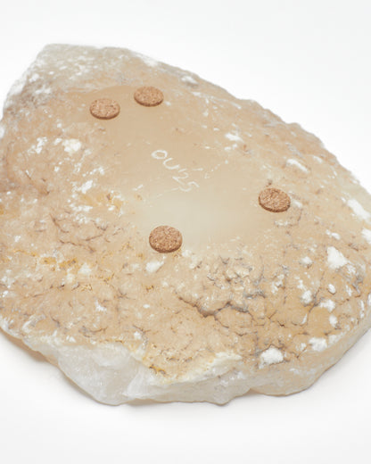 Underside: white translucent alabaster tray with raw surface, flecks, cork pads, OU'25 engraving.