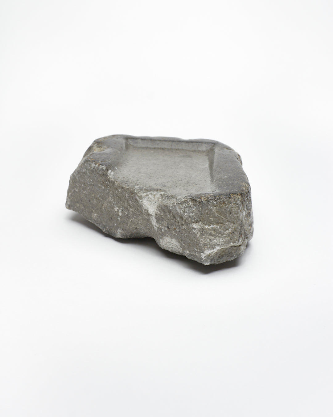 Front-on view: organic-rectangle-shaped gray stone tray with raw edges.