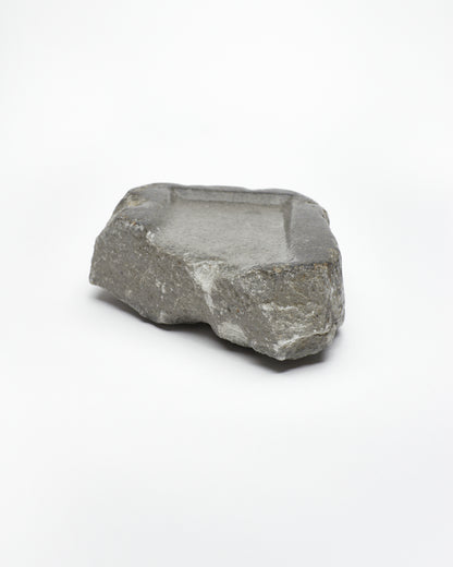Front-on view: organic-rectangle-shaped gray stone tray with raw edges.