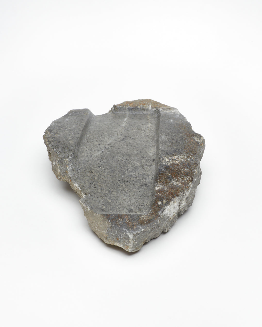 Front: organic-shaped gray stone tray with raw edges, brown and white flecks, subtle veining.