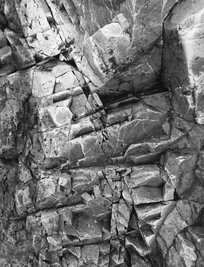 Close-up, black & white photo of textured rocks.